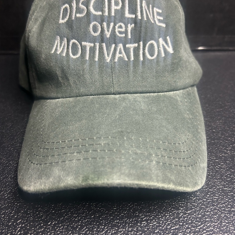 Green Dad Hat with “Discipline Over Motivation” in White Embroidered